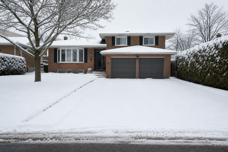 Illustrative GTA West driveway covered by a recent snowfall before clearing
